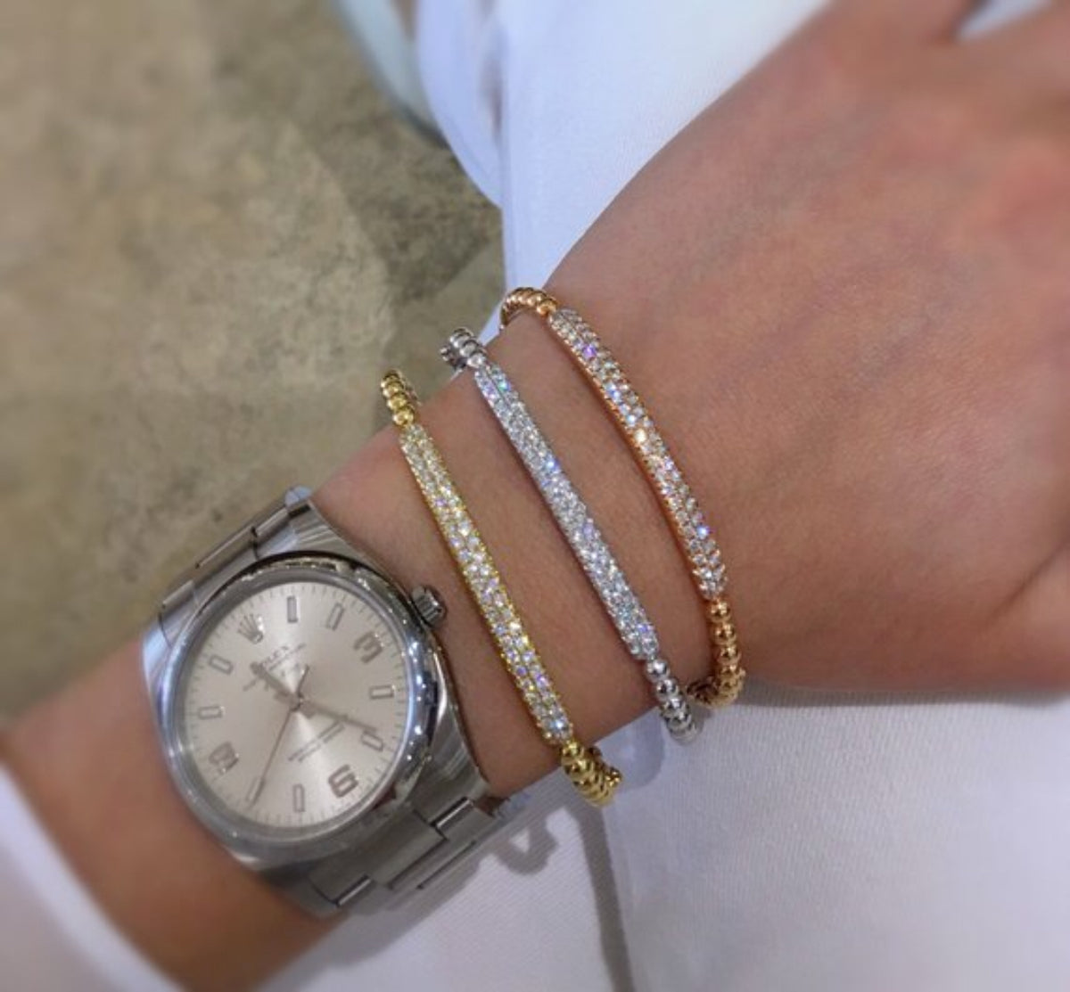 Female Model Wearing Diamond Bar Beaded Bangle Bracelet  -14K gold weighing 9.69 grams  -50 round pave-set diamonds totaling 0.88 carats.