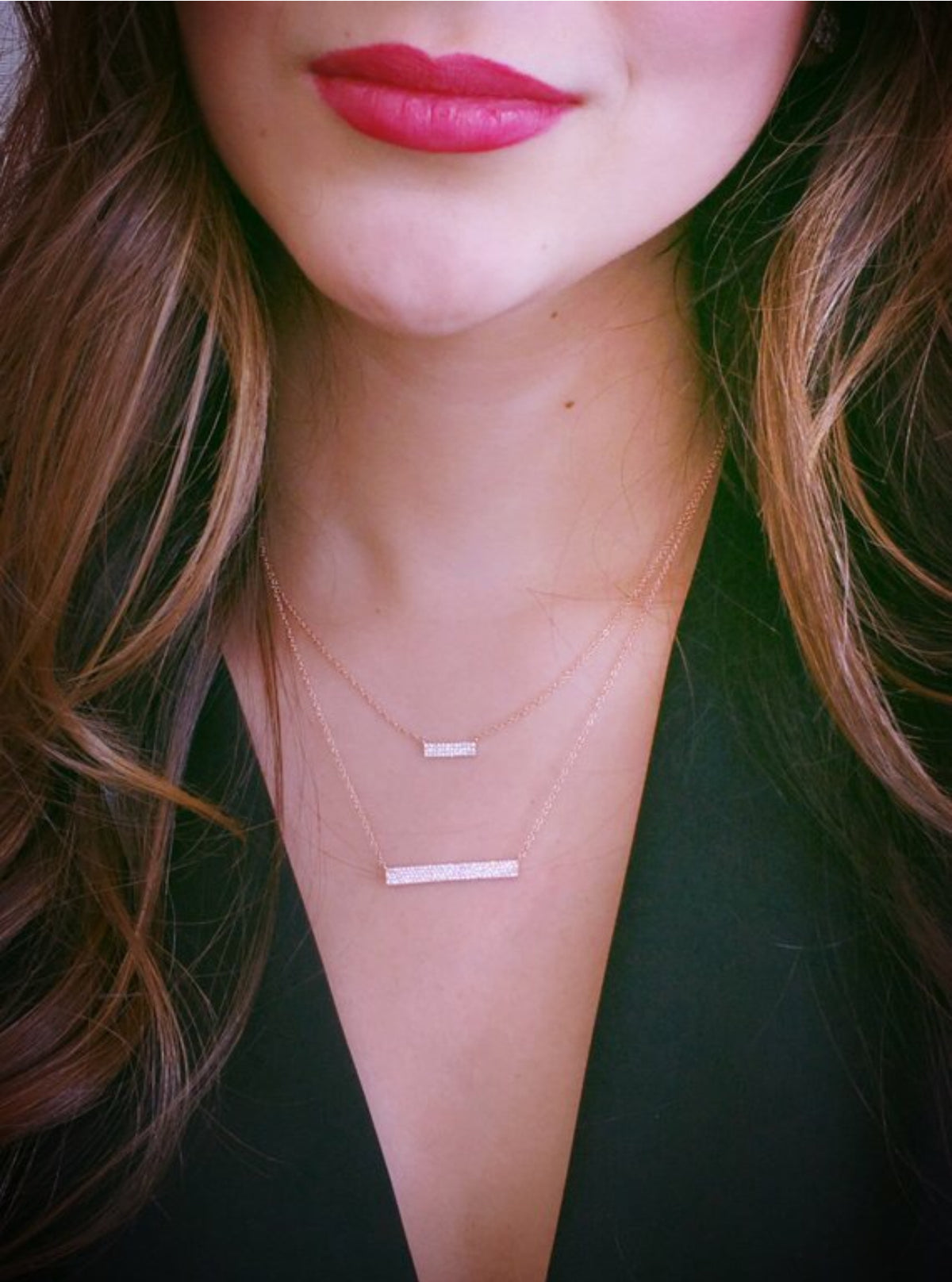 Female model wearing Pave Diamond Bar Necklace  -14K yellow gold weighing 2.22 grams  -118 round pave-set diamonds totaling 0.27 carats.