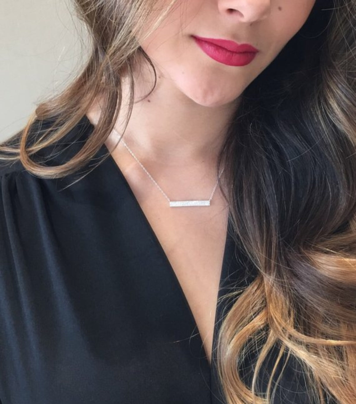 Female model wearing Pave Diamond Bar Necklace  -14K white gold weighing 2.22 grams  -118 round pave-set diamonds totaling 0.27 carats.