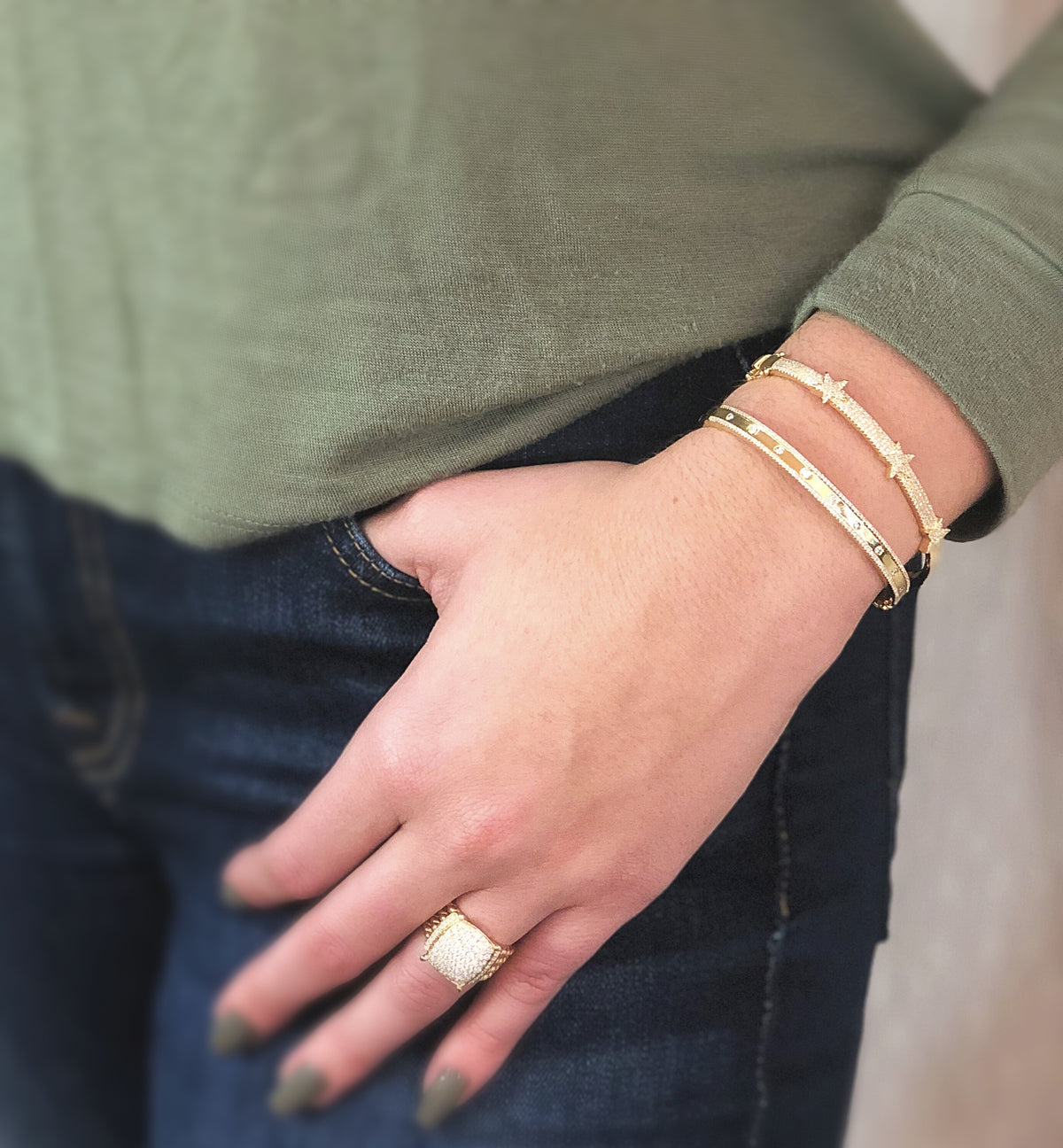 Female Model Wearing Diamond Tri-Star Bangle Bracelet  -14K gold weighing 13.48 grams  -301 round diamonds totaling 0.75 carats