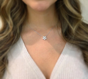 Female Model Wearing Diamond Flower Necklace  14k gold, 3.78 grams, 5 pear-shaped prong-set diamonds .47 carats, 1 round prong-set diamond .05 carats, 27 round prong-set diamonds .18 carats.  Size width 12.5 millimeters.