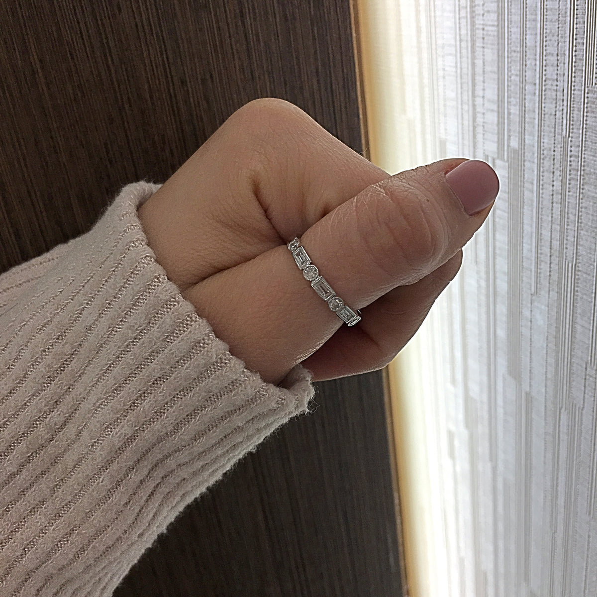 Female Model Wearing Round & Baguette diamond Stacking Ring with Antique Milgrain  - 18k gold, 2.78 grams,  - 4 straight bezel-set baguettes .15 carats,  - 5 round bezel-set diamonds .15 carats.