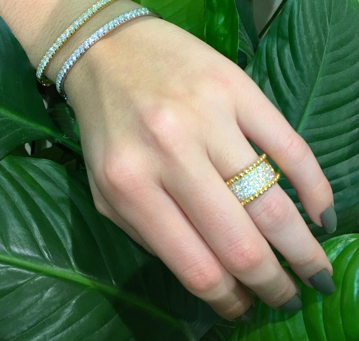 Female Model Wearing Wide Diamond Band with Gold Bead Edge  18k gold, 10.20 grams, 79 shared prong set round brilliant cut diamonds .90 carats.  Measures 11.00 millimeters width.