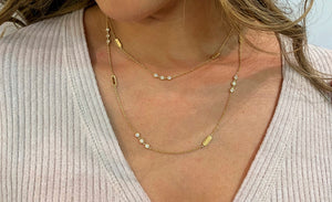 Female model wearing Layered Diamond Station Necklace -18k gold 11.91 grams -24 round bezel-set diamonds 1.78 carats