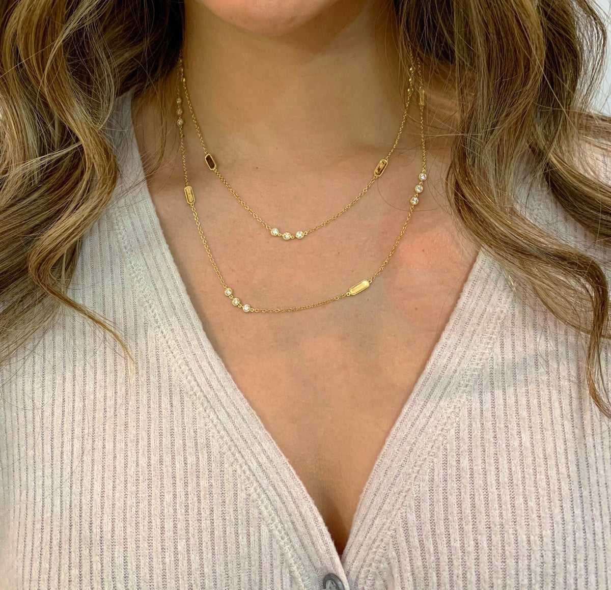 Female model wearing Layered Diamond Station Necklace -18k gold 11.91 grams -24 round bezel-set diamonds 1.78 carats