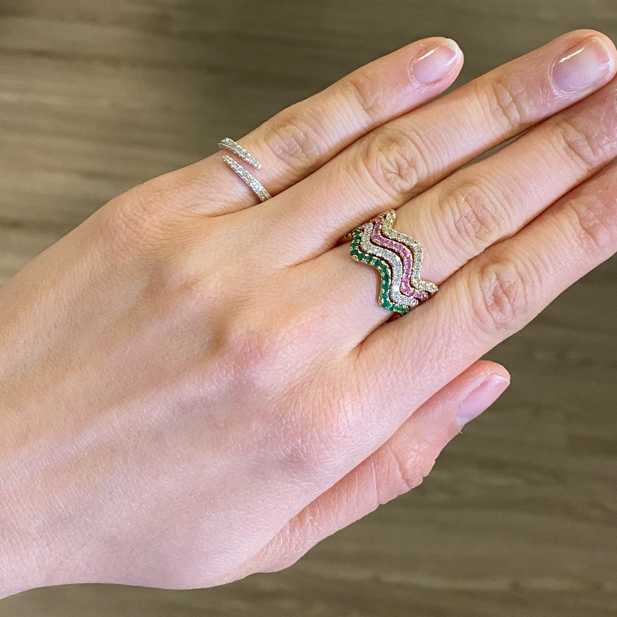 Female model wearing Solid 14K yellow gold weighing 1.38 grams with 40 round diamonds totaling 0.19 carats Open Wrap Pinky Ring | Nuha Jewelers