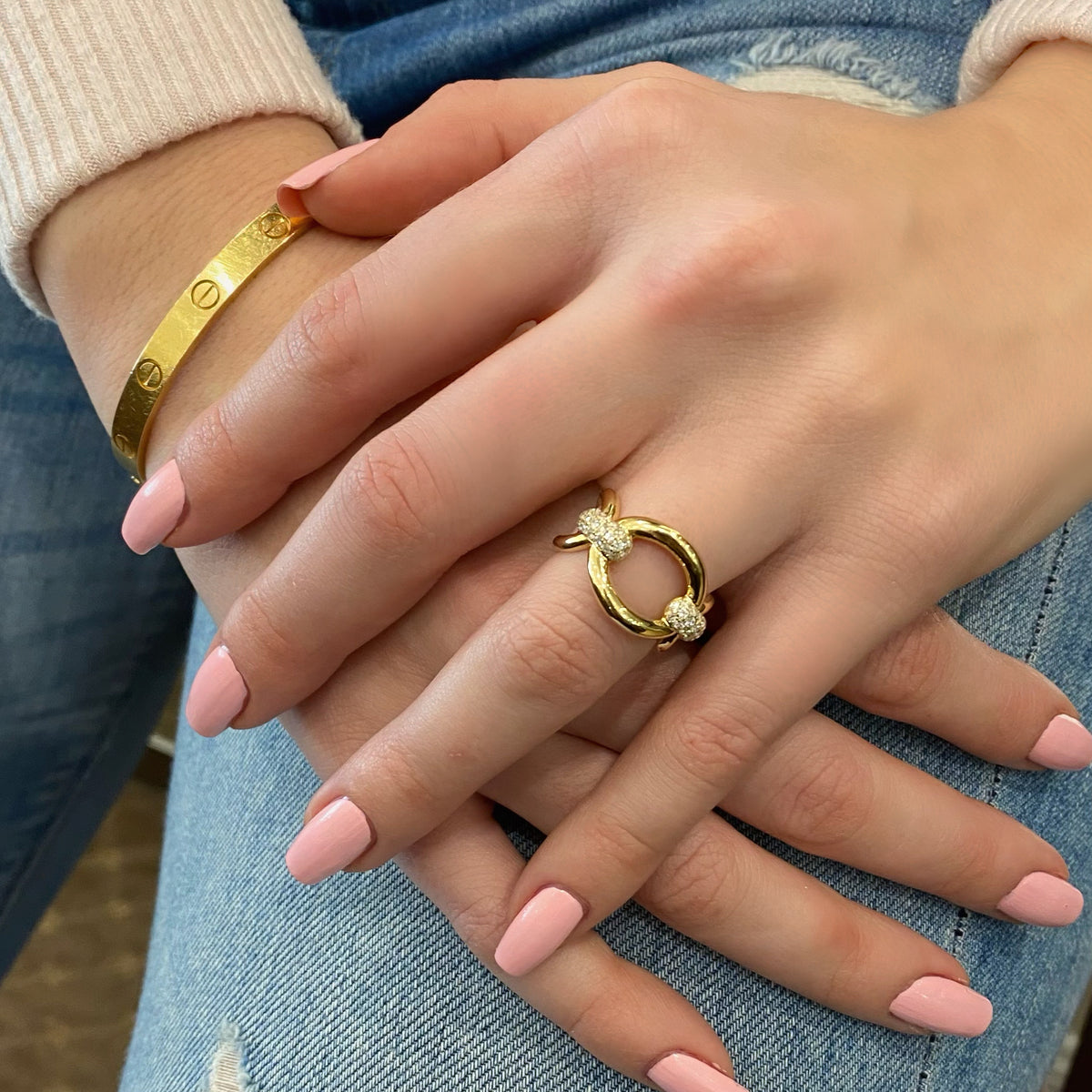 Female model wearing Diamond Bold Loop Ring  - 14K gold weighing 4.01 grams  - 44 round diamonds totaling 0.46 carats