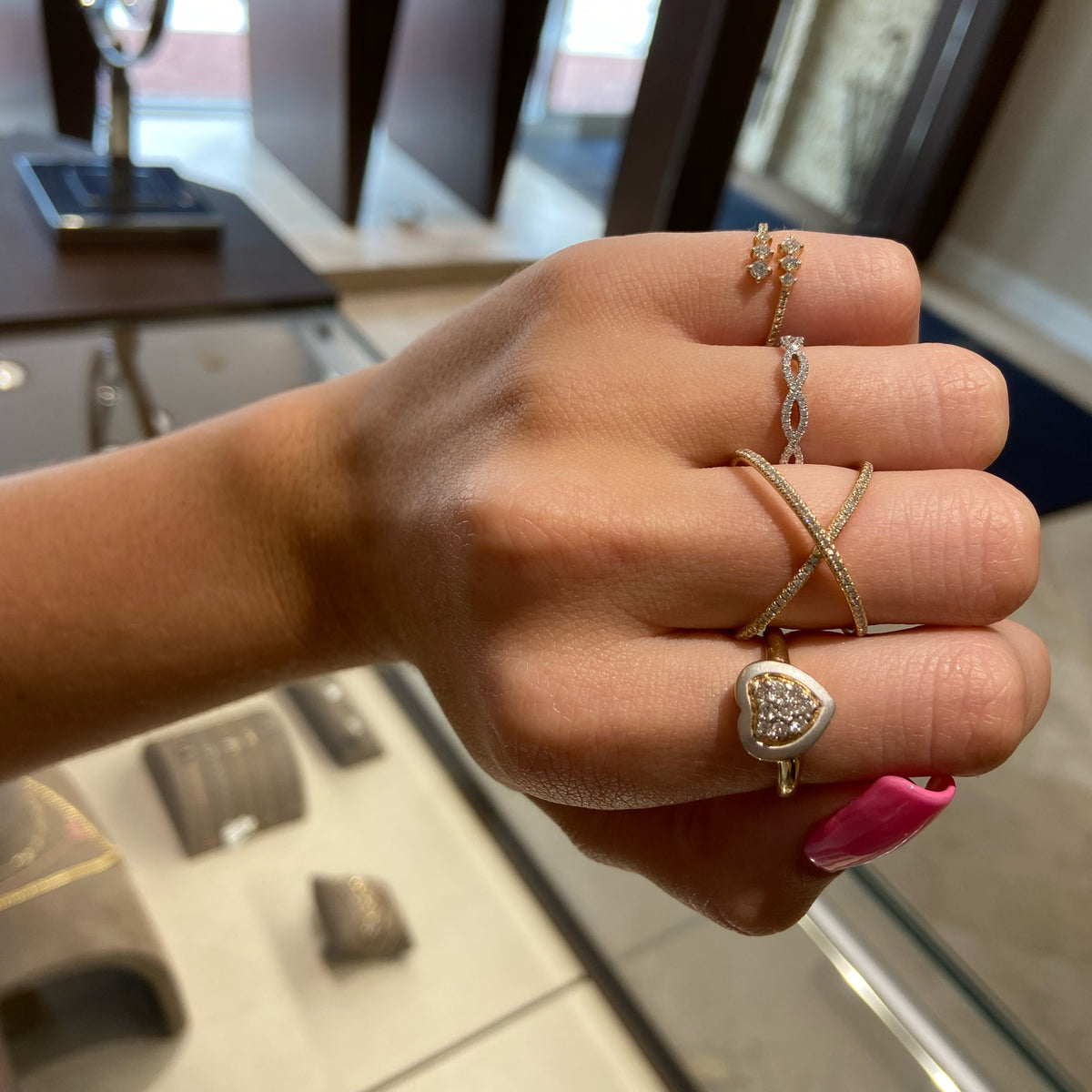 Female model wearing Graduated Diamond Wrap Pinky Ring  - 14K yellow gold weighing 1.23 grams  - 22 round diamonds totaling 0.25 carats