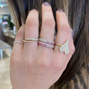 Female Model Wearing Gradient Diamond and Pink Sapphire Eternity Ring  -14K gold weighing 1.42 grams  -20 round diamonds totaling 0.26 carats  -21 pink sapphires totaling 0.38 carats