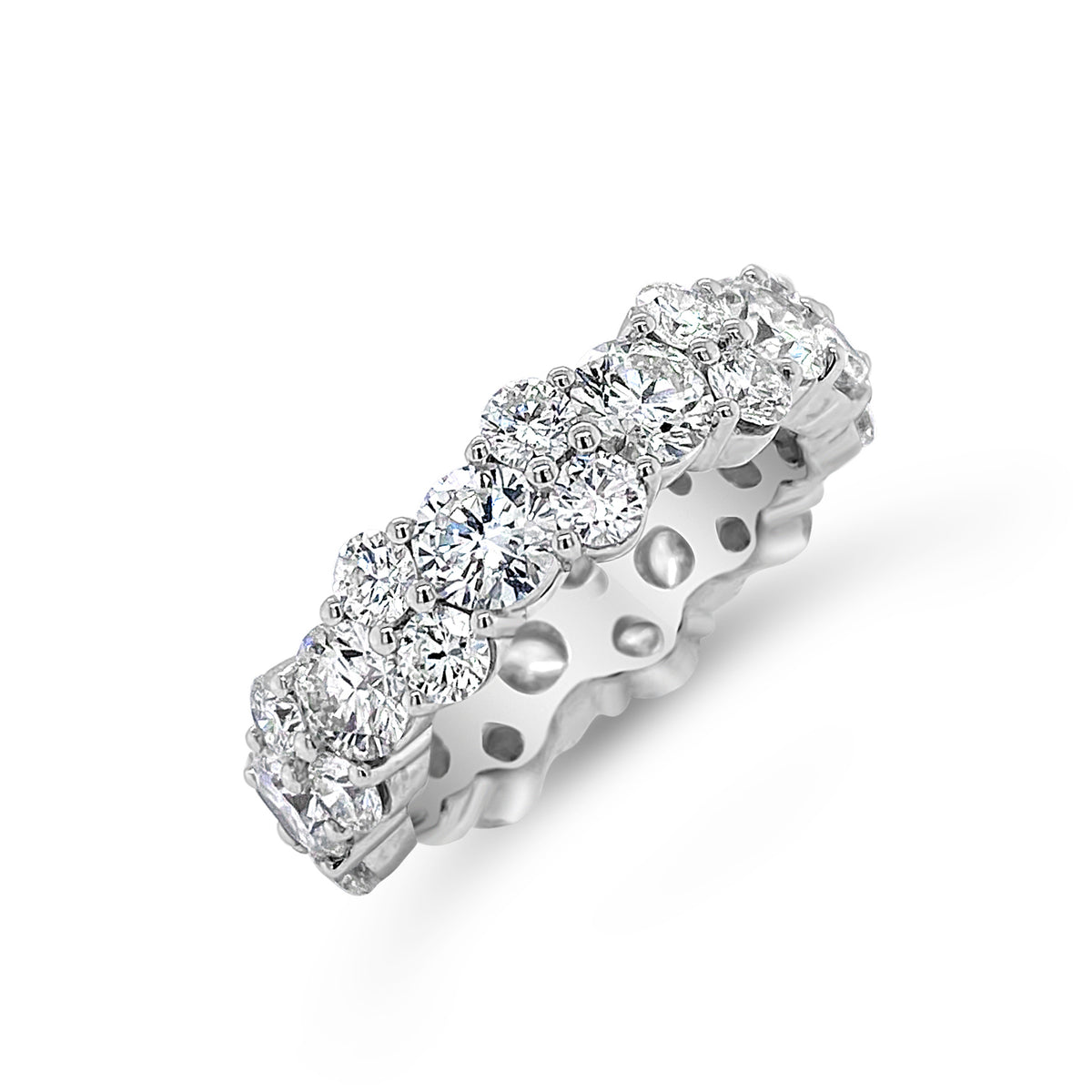 Staggered Diamond Eternity Band Lg   -18K gold weighing 6.91 grams  -11 round diamonds totaling 3.15 carats  -22 round diamonds totaling 1.87 carats