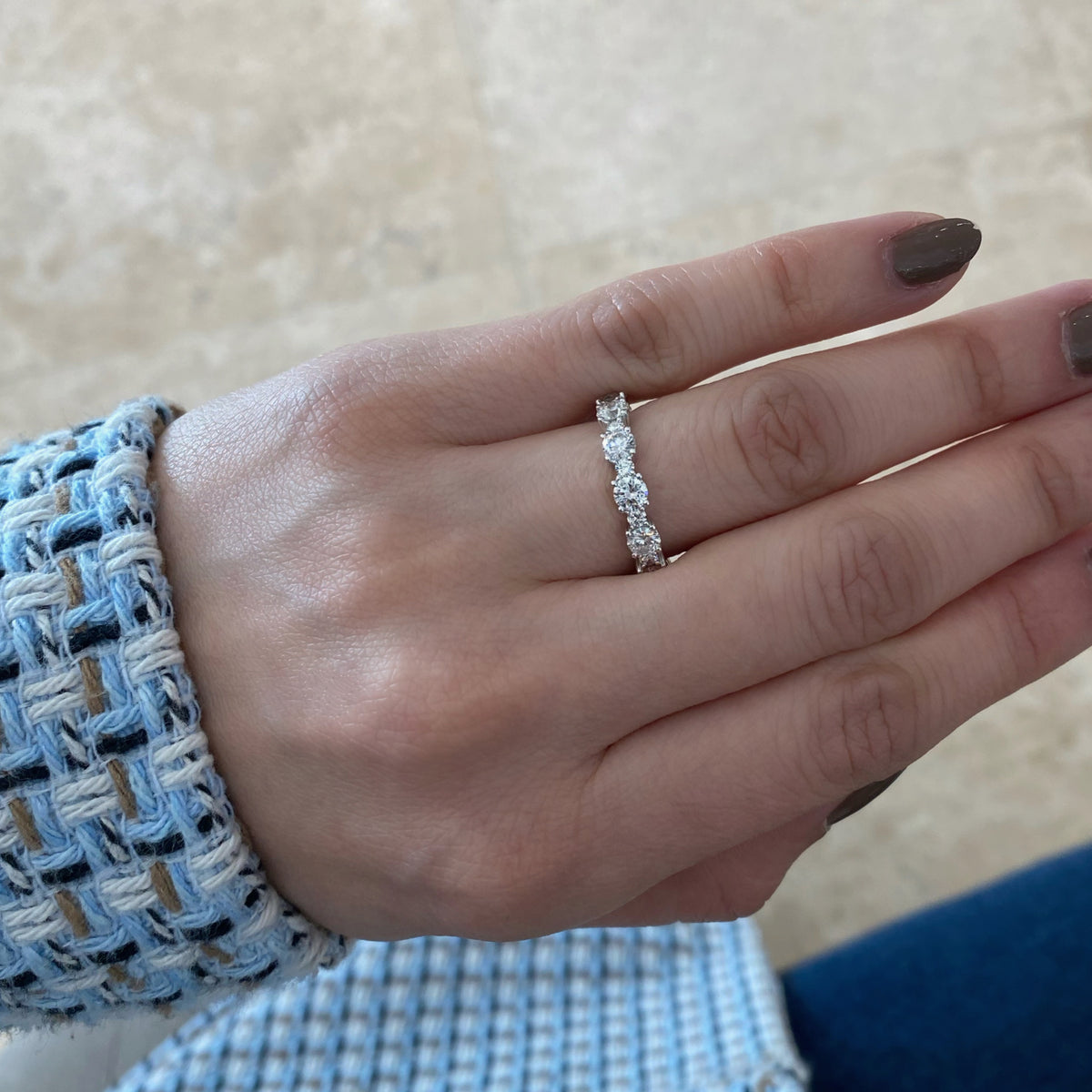 Female Model Wearing Diamond Eternity Band   -18K gold weighing 3.07 grams  -12 round diamonds totaling 2.13 carats  -12 round diamonds totaling 0.43 carats