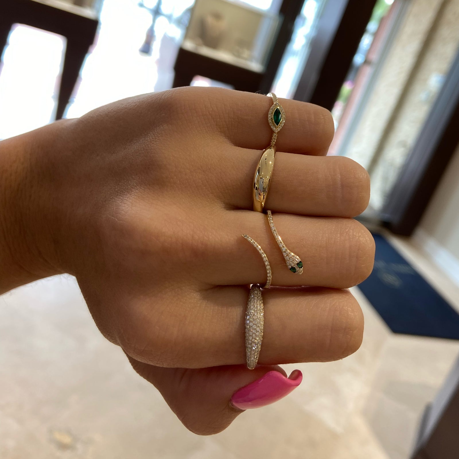 Diamond & Emerald Snake Ring - 14K yellow gold weighing 1.72 grams  - 44 round diamonds totaling 0.11 carats  - 2 emeralds totaling 0.02 carats