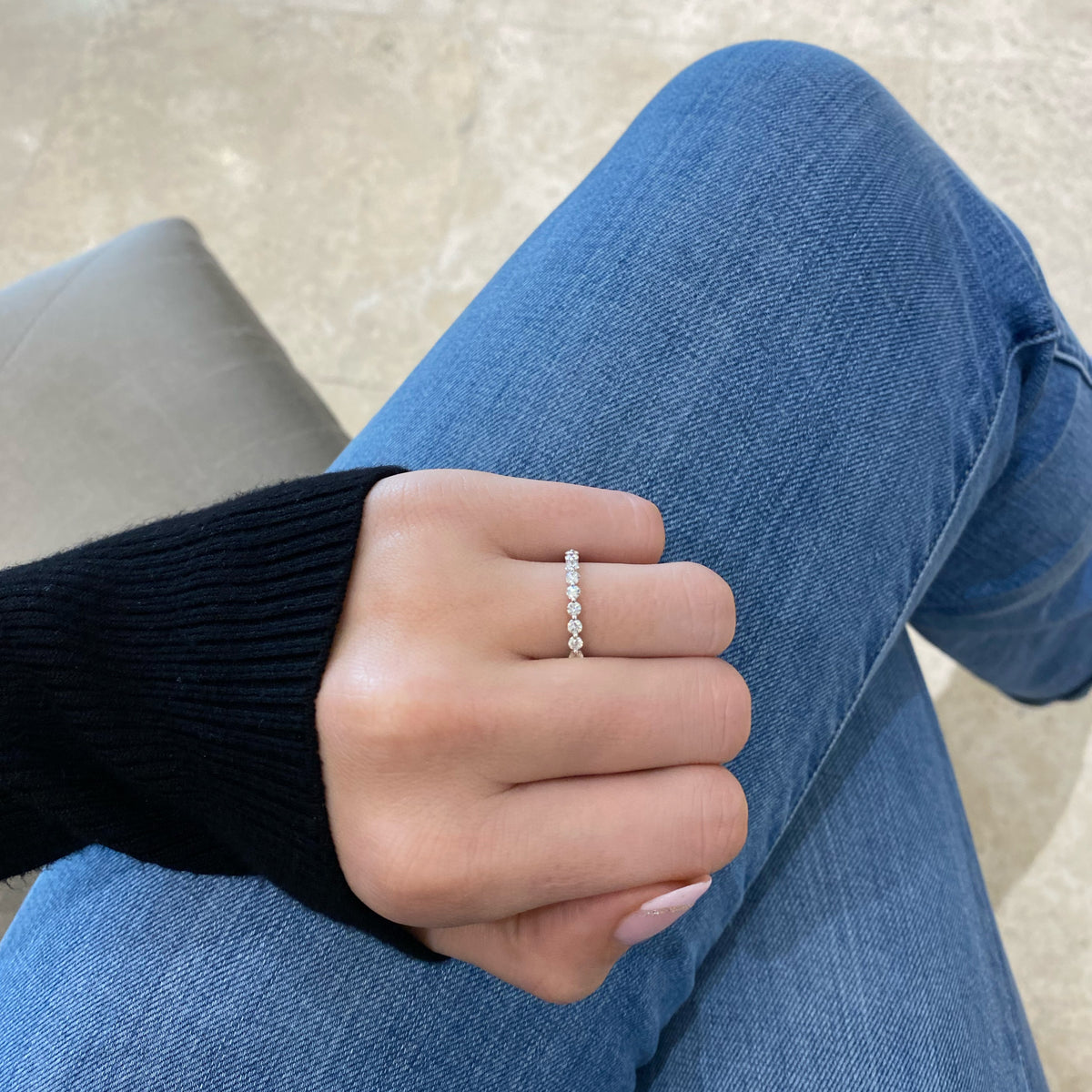 Female model wearing Single-Prong Diamond Eternity Ring- 18K white gold weighing 1.65 grams - 23 round diamonds weighing 1.15 carats