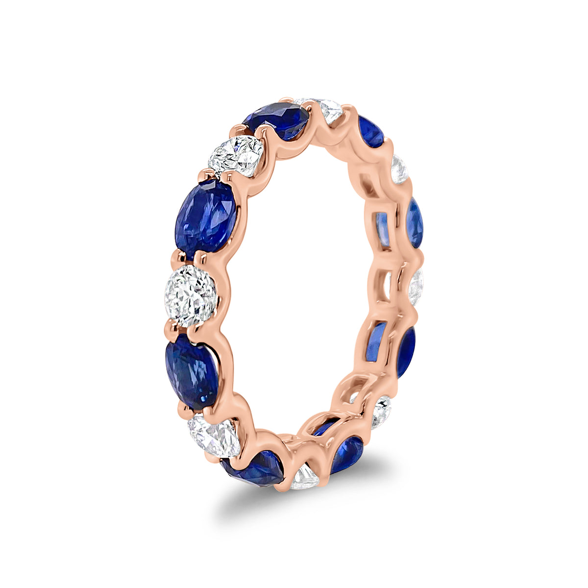Sapphire & Diamond Eternity Ring - 18K gold weighing 2.67 grams - 8 round diamonds totaling 1.10 carats - 8 oval-shaped sapphires totaling 2.46 carats