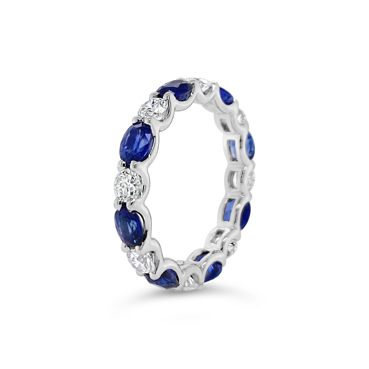 Sapphire & Diamond Eternity Ring - 18K gold weighing 2.67 grams - 8 round diamonds totaling 1.10 carats - 8 oval-shaped sapphires totaling 2.46 carats
