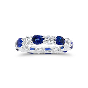 Sapphire & Diamond Eternity Ring - 18K gold weighing 2.67 grams - 8 round diamonds totaling 1.10 carats - 8 oval-shaped sapphires totaling 2.46 carats