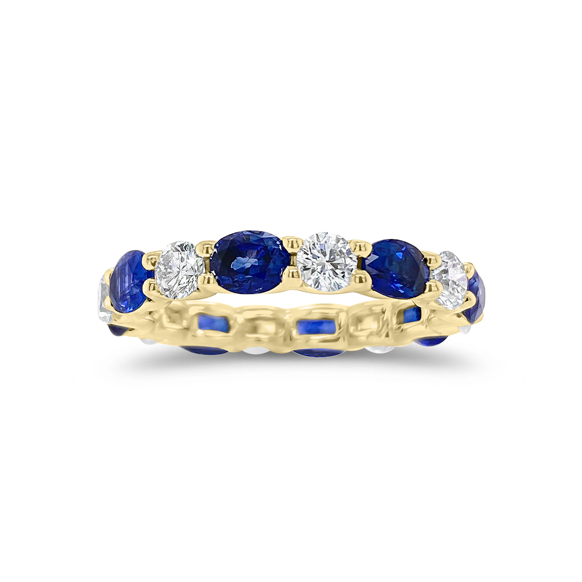 Sapphire & Diamond Eternity Ring - 18K gold weighing 2.67 grams - 8 round diamonds totaling 1.10 carats - 8 oval-shaped sapphires totaling 2.46 carats