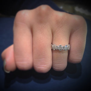 Female Model Wearing Alternating Bezel-Set Diamond Eternity Ring with Antique Milgrain