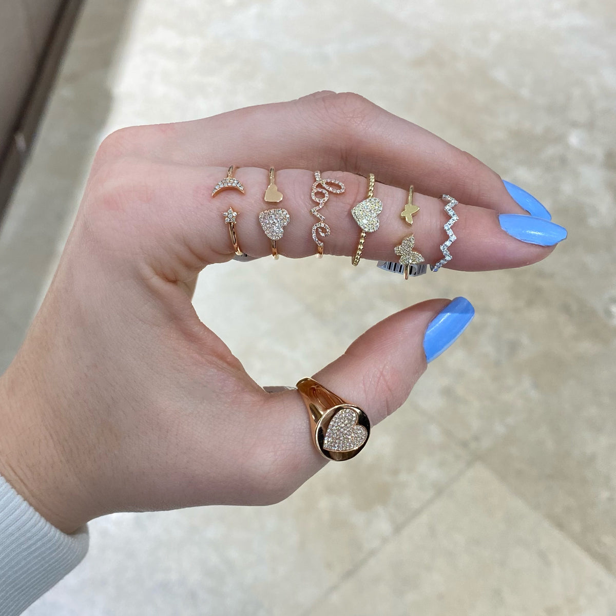 Female model wearing Diamond Zig-zag Pinky Ring- 14K white gold weighing 0.84 grams  - 17 round diamonds totaling 0.13 carats