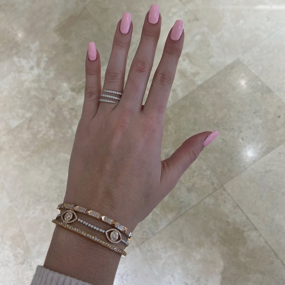 Female model wearing Skinny Pave Diamond Pyramid Stud Bangle Bracelet - 14K gold weighing 13.86 grams - 252 round diamonds totaling 0.95 carats