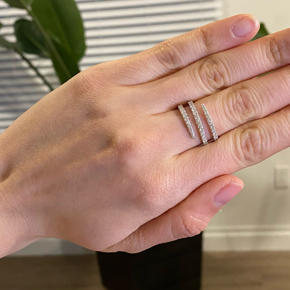 Female Model Wearing Diamond Swirl Fashion Ring  -14k gold weighing 3.89 grams  -37 round diamonds weighing .64 carats