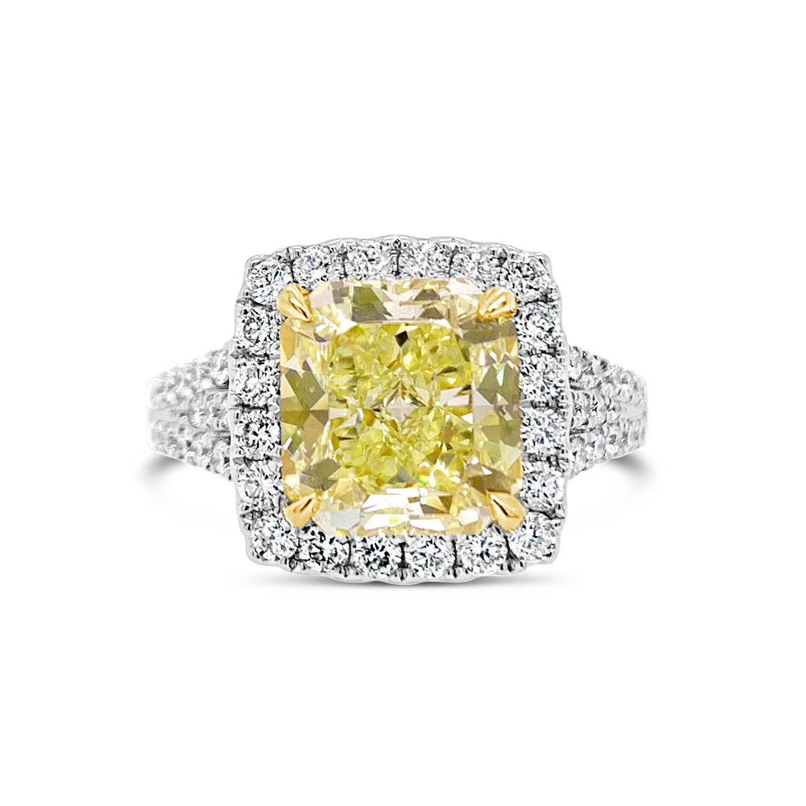 Fancy Light Yellow Radiant Halo Diamond Engagement Ring  - 18 kt white gold weighting 6.09 grams  - 68 round diamonds totaling 0.93 carats  - 1 Fancy light yellow radiant cut totaling 3.29 VS2-GIA