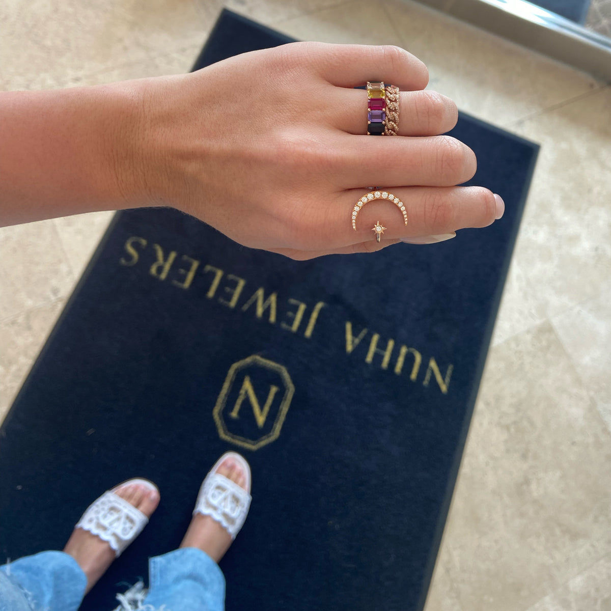 Female model wearing Crescent Moon and Star Diamond Ring - 14k yellow gold weighting 2.61 grams. - 20 round shared prong-set diamonds .36 carats.