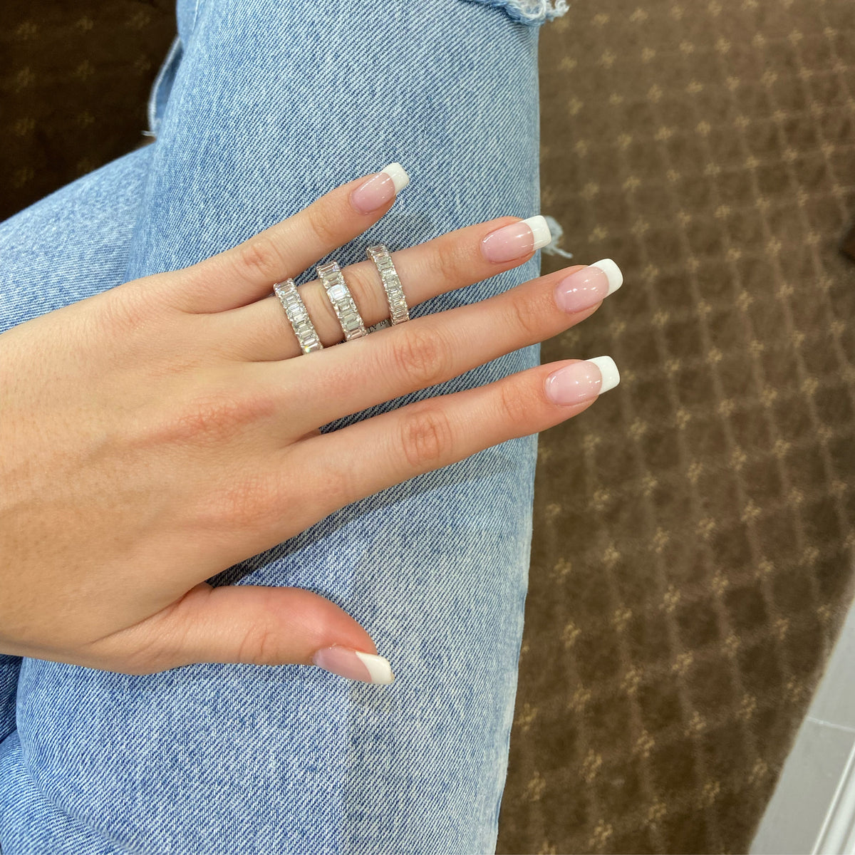 Female Model Wearing Platinum Emerald Cut Diamond Eternity Band  Platinum, 17 Emerald-cut diamonds 8.85 carats D-G-VS+ 15GIA