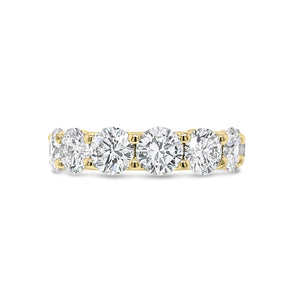 Diamond Eternity Ring  - 18K gold weighing 9.20 grams  - 13 round diamonds totaling 6.87 carats (GIA-graded E-G color, VVS2-SI2 clarity)