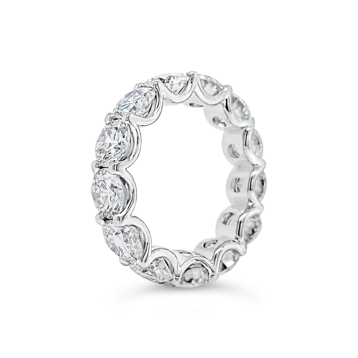 Diamond Eternity Ring  - 18K gold weighing 9.20 grams  - 13 round diamonds totaling 6.87 carats (GIA-graded E-G color, VVS2-SI2 clarity)