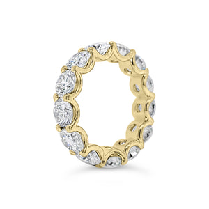 Diamond Eternity Ring  - 18K gold weighing 9.20 grams  - 13 round diamonds totaling 6.87 carats (GIA-graded E-G color, VVS2-SI2 clarity)