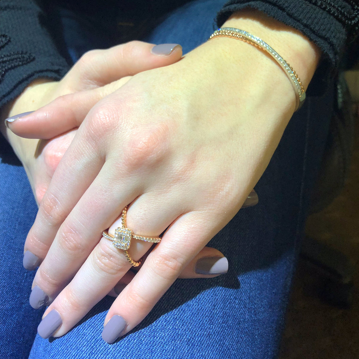 Female Model Wearing Diamond Criss-cross with Baguette Center Fashion Ring  -18k gold weighing 5.39 grams  -42 round diamonds weighing .40 carats  -4 straight baguettes weighing .08 carats