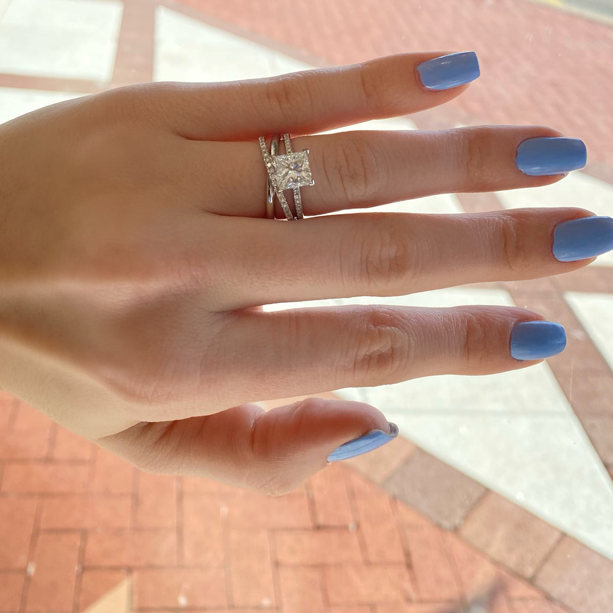 Female Model Wearing Interlocking Two-Tone Diamond Ring  -14k gold, 2.50 grams,  -51 round shared prong-set brilliant diamonds .36 carats.