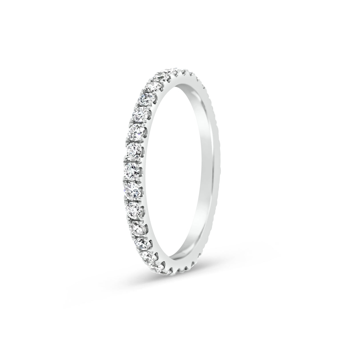 Slim Four Prong-Set Diamond Eternity Band  -18k gold weighing 1.60 grams  -34 round four prong-set diamonds weighing .71 carats