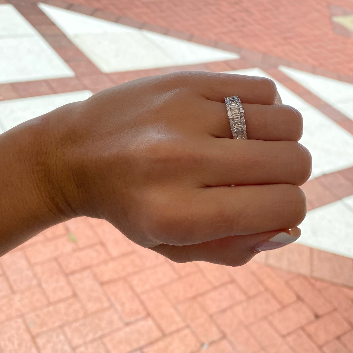 Female Model Wearing Diamond Baguettes Wedding Band - 18K gold weighing 4.16 grams  - 25 straight baguettes totaling 1.13 carats  - 20 round diamonds totaling 0.15 carats