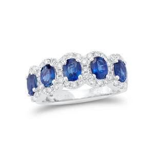 Oval cut blue sapphire & diamond halo band -18k gold weighing 5.68 grams  -5 oval prong-set sapphires totaling 2.05 carats  -48 round diamonds totaling .63 carats.