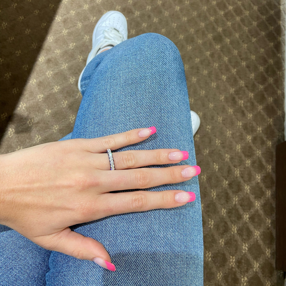 Female model wearing Sapphire gemstone & diamond eternity wedding band -18k gold weighing 3.91 grams  -23 round diamonds weighing 1.89 carats  -46 sapphire gemstones weighing 2.79 carats