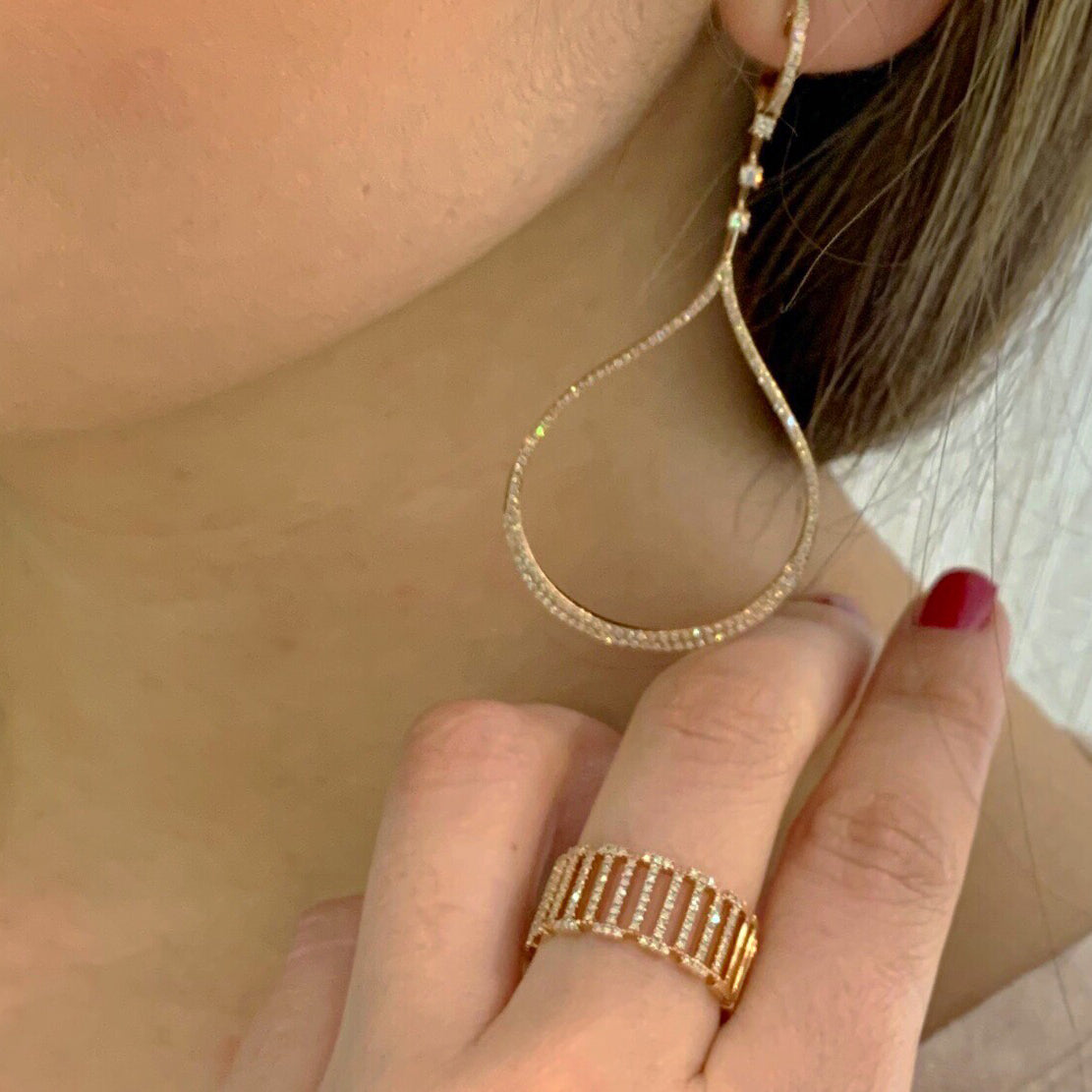 Female Model Wearing Diamond Cut-out Ring  - 14k gold weighting 4.70 grams.  - 0.31 carats of round four prong-set diamonds. 