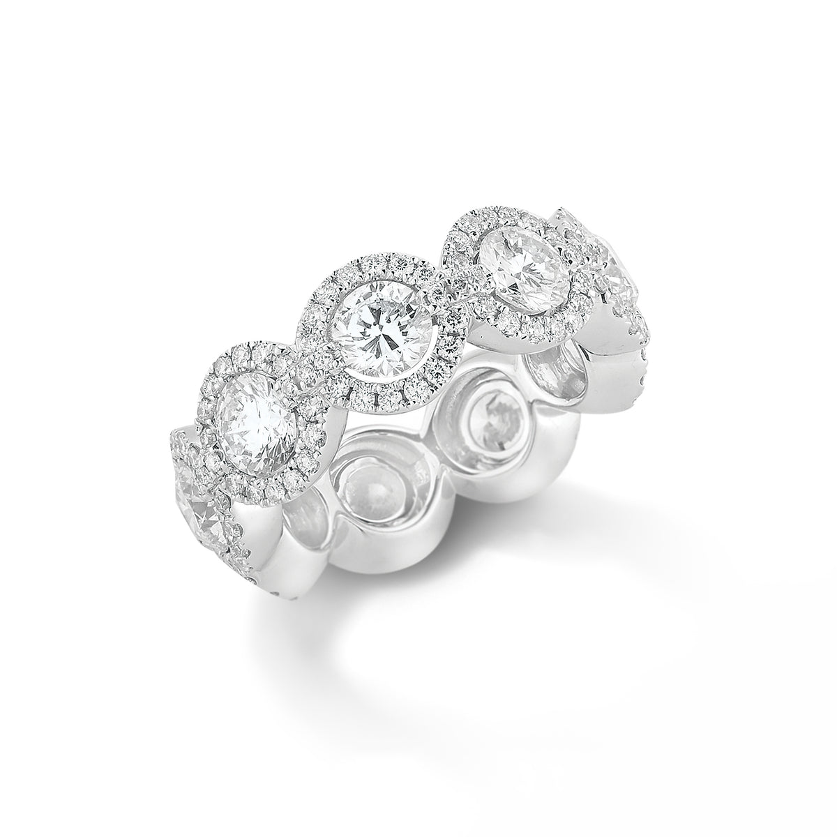 Halo Diamond Eternity Band  -18k gold, 7.95 grams, 153 round shared prong-set brilliant diamonds 1.09 carats.  - 9 round brilliant diamonds 4.12 carats.