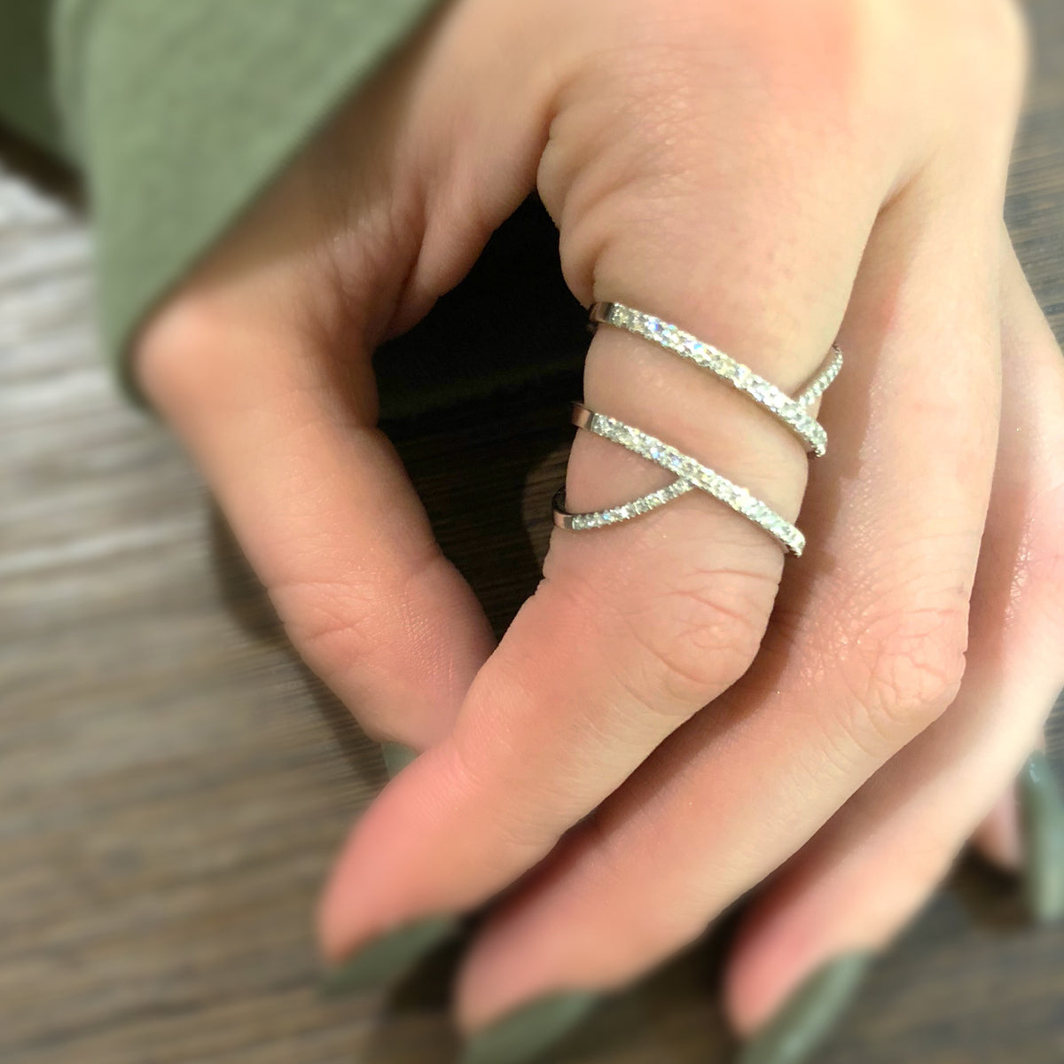 Female Model Wearing Diamond Cut-out Fashion Ring  -14k gold weighing 5.20 grams  -54 round shared prong-set diamonds weighing .52 carats