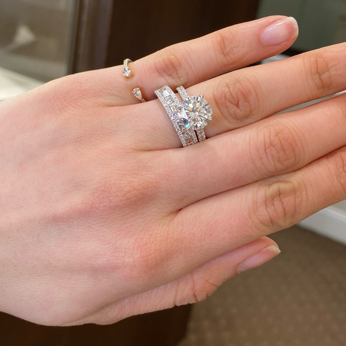 Multi-Shape Diamond Wedding Band  - 18K gold weighing 4.93 grams  - 4 slim baguettes totaling 0.43 carats  - 5 round diamonds totaling 0.35 carats  - 48 round diamonds totaling 0.22 carats