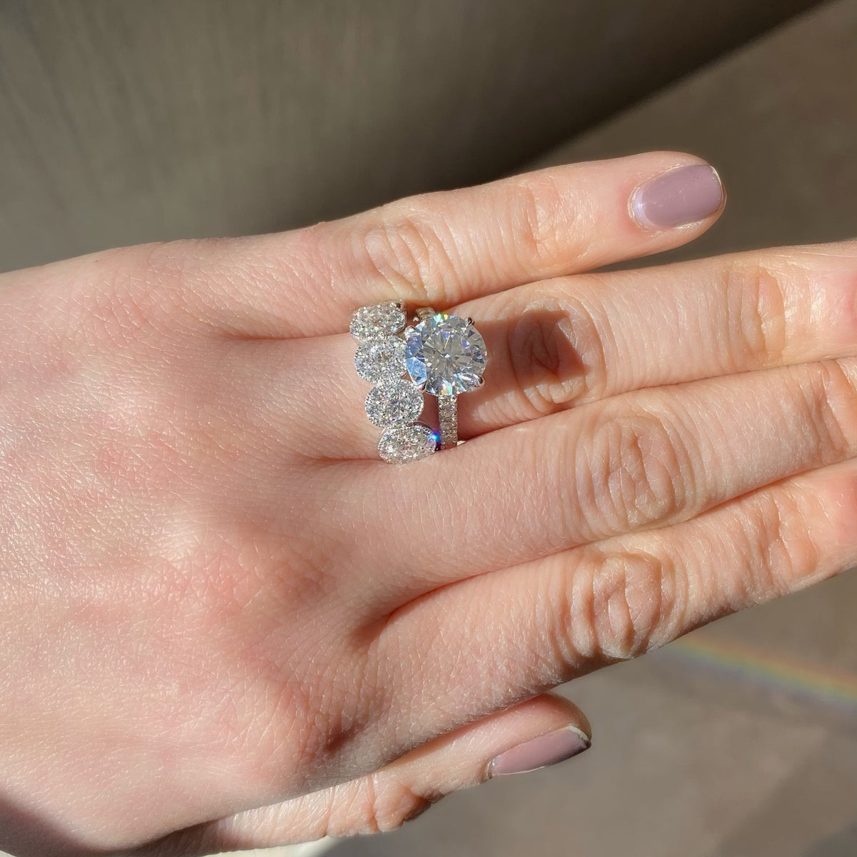 Halo Diamond Ovals Wedding Band  - 18K gold weighing 4.13 grams  - 5 round diamonds totaling 0.57 carats  - 4 round diamonds totaling 0.79 carats