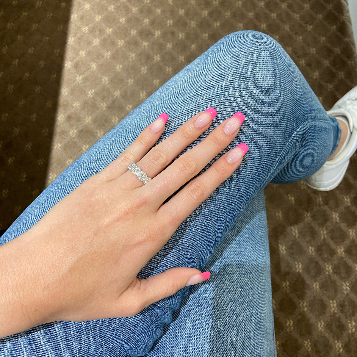 Female Model Wearing Diamond Cushion Wedding Band  - 18K gold weighing 3.89 grams  - 5 round diamonds totaling 0.50 carats  - 40 round diamonds totaling 0.85 carats