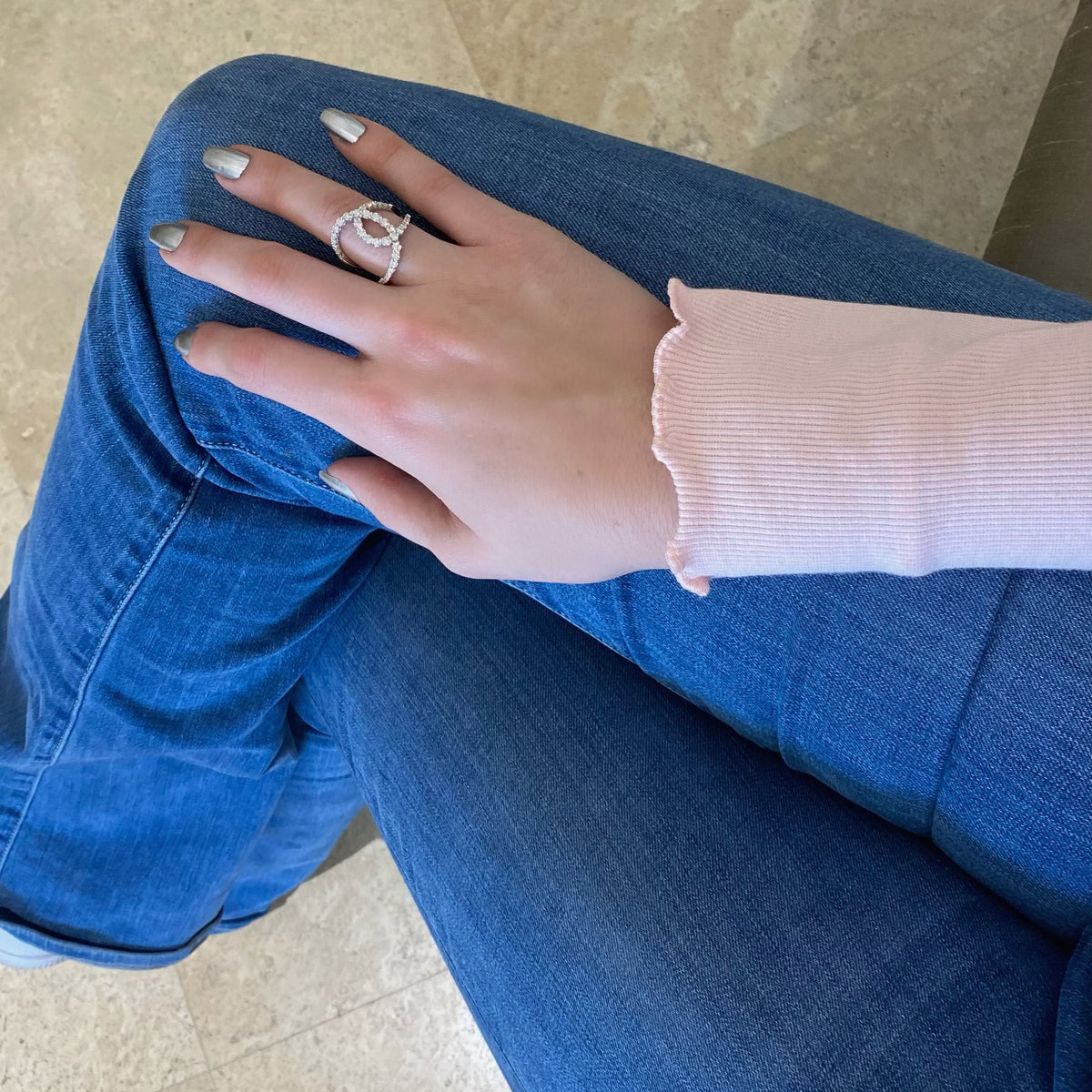 Female Model Wearing Diamond Open Loop Ring  -18K gold weighing 5.31 grams  -39 round diamonds totaling 1.40 carats