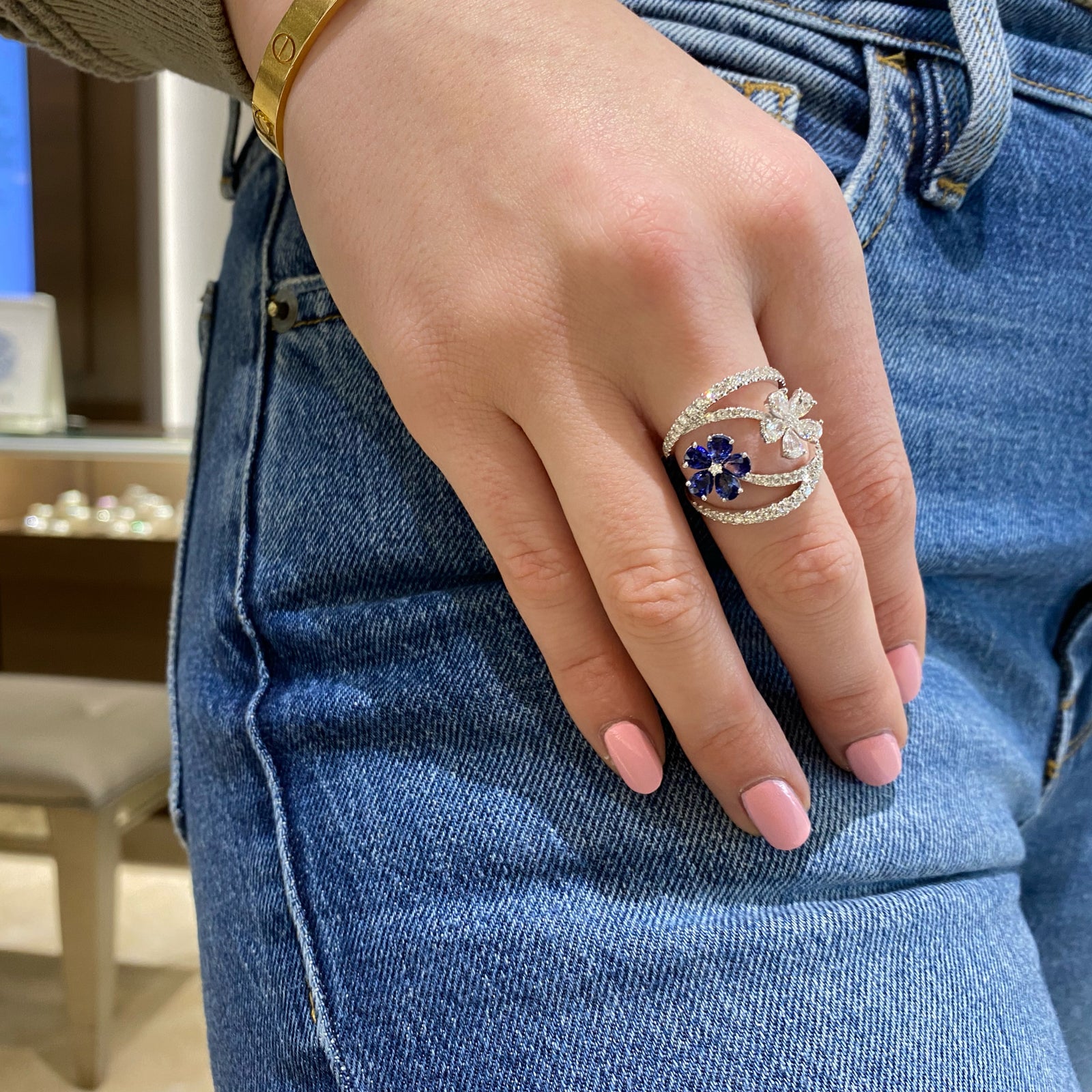 Diamond & Sapphire Flower Wrap Ring- 18K gold weighing 5.61 grams  - 56 round diamonds weighing 0.74 carats  - 5 pear-shaped sapphires weighing 1.49 carats  - 5 pear-shaped diamonds weighing 0.75 carats