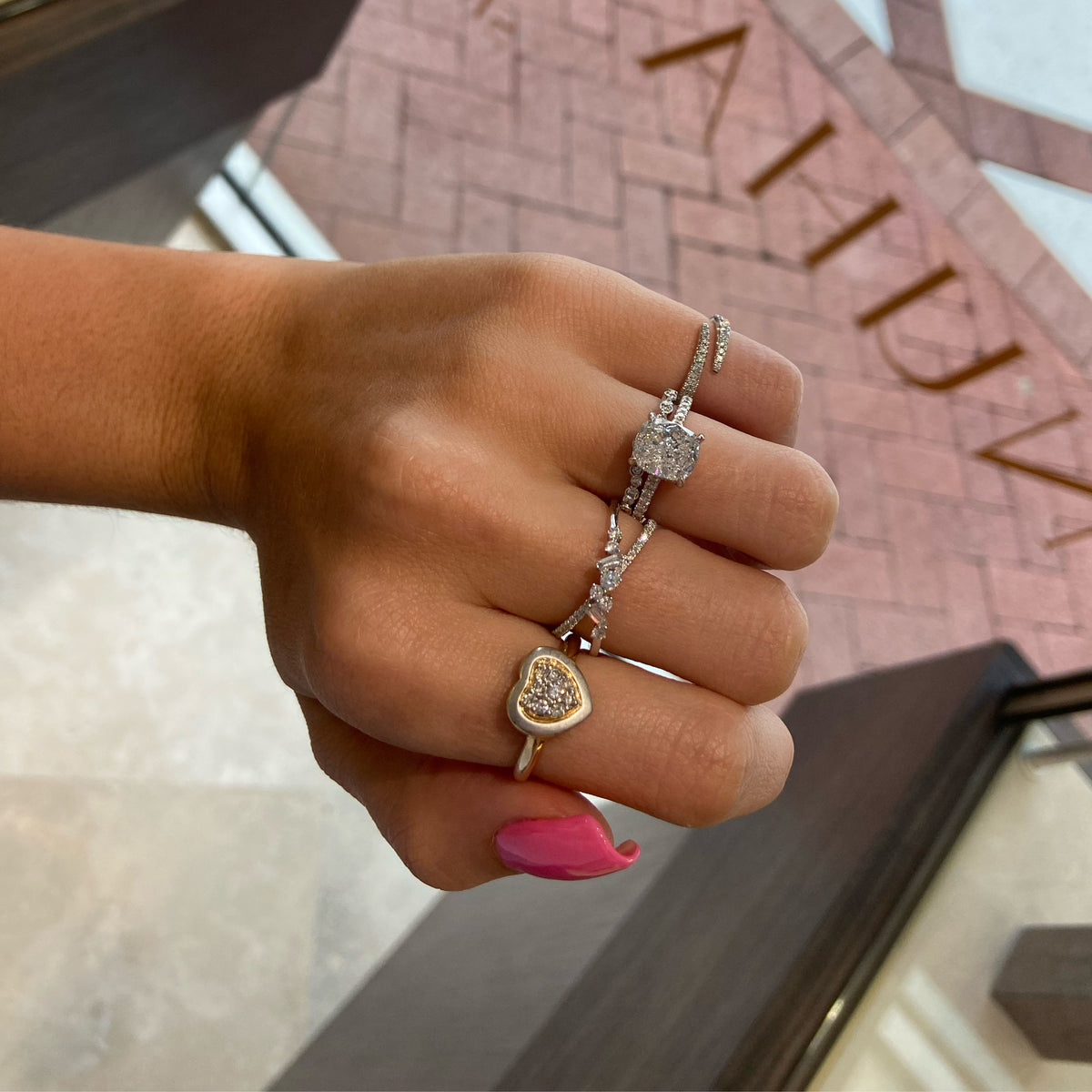 Female Model Wearing Mixed Cut Diamond Criss-Cross Ring  - 18K gold weighing 3.08 grams  - 31 round diamonds totaling 0.30 carats  - 2 tapered baguettes totaling 0.09 carats