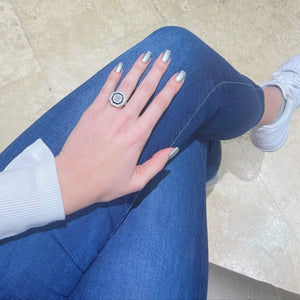 Female Model Wearing Octagonal Diamond & Sapphire Right Hand Ring  -18k gold weighing 8.13 grams  -84 round diamonds weighing .56 carats  -24 princess-cut sapphires weighing .89 carats  -1 princess-cut diamond weighing 1.13 carats with G-I2 (GIA clarity standards)