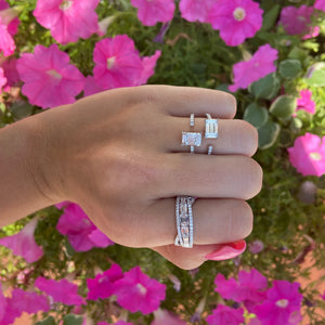 Female model wearing Diamond Baguette Double Claw Ring - 18K white gold weighing 4.59 grams - 10 slim baguettes totaling 0.80 carats - 33 round diamonds totaling 0.32 carats