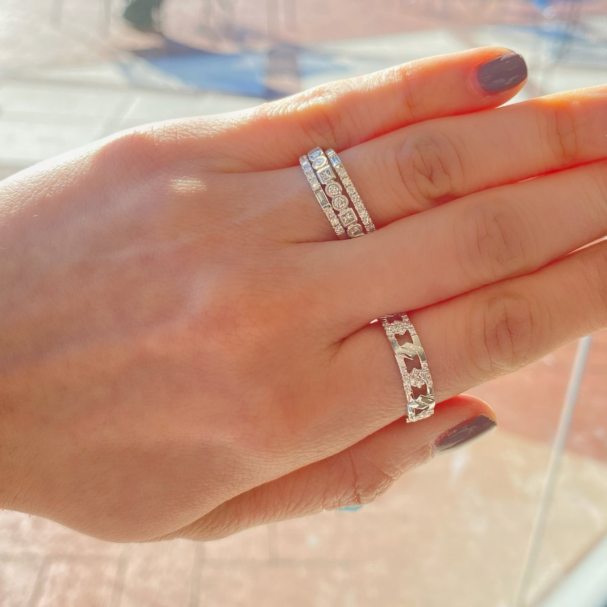 Female Model Wearing Diamond Multi-Shape Wedding Band with Milgrain  - 18K gold weighing 2.65 grams  - 8 round diamonds totaling 0.24 carats  - 3 princess-cut diamonds totaling 0.13 carats