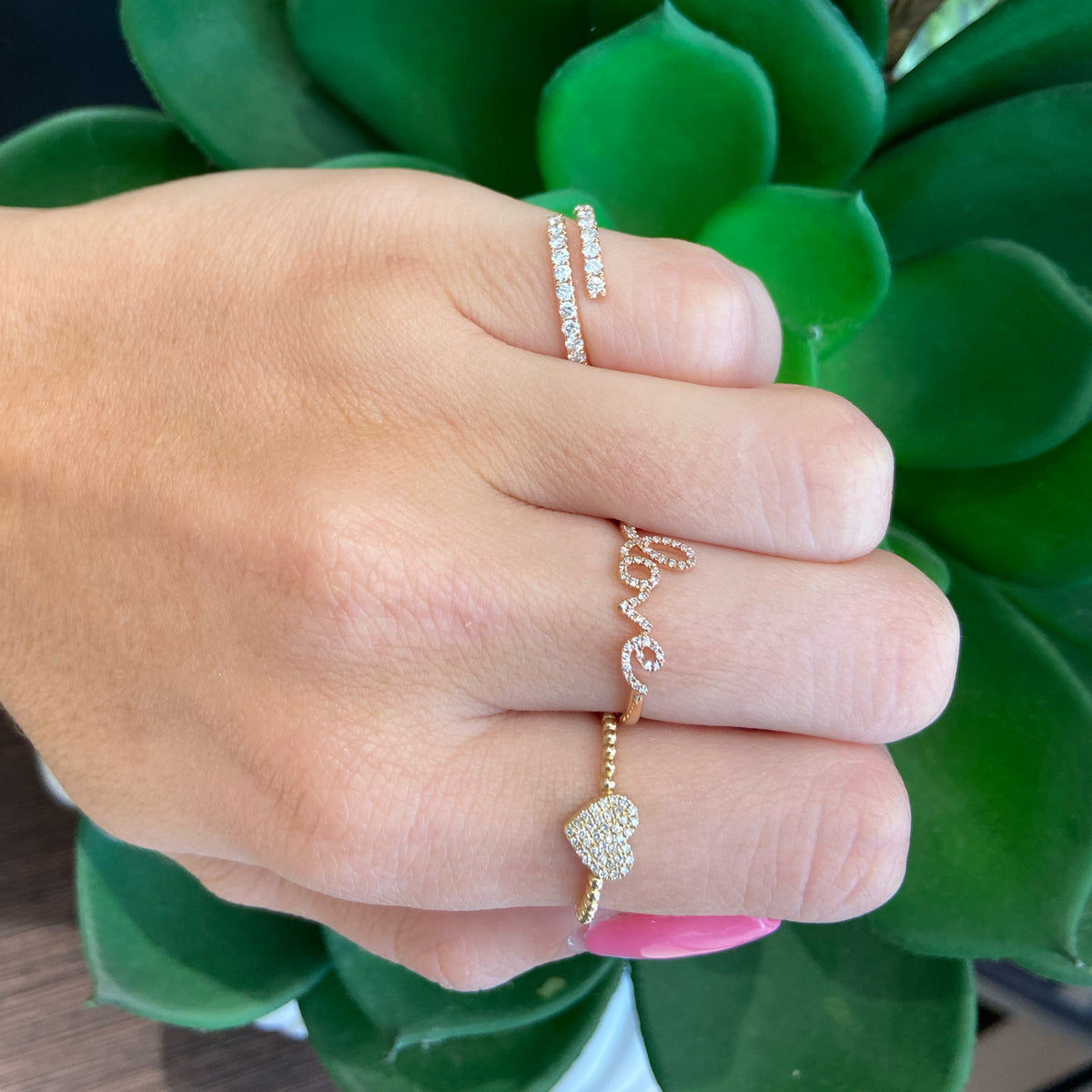 Female model wearing Diamond Simple Wrap Pinky Ring  - 14K gold weighing 2.12 grams  - 24 round diamonds totaling 0.52 carats